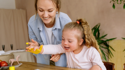 Young woman and girl enjoying arts and crafts